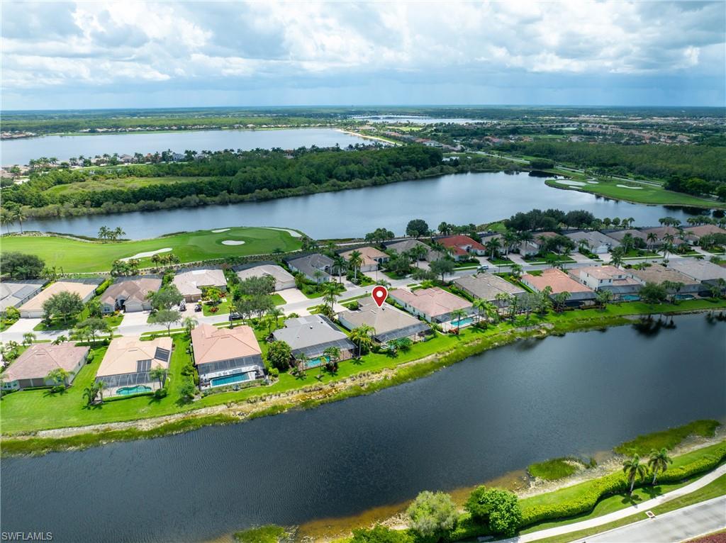 9774 Nickel Ridge Circle Naples, FL 34120 - Photo 35 of 50 an aerial view of lake residential house with swimming pool and outdoor space