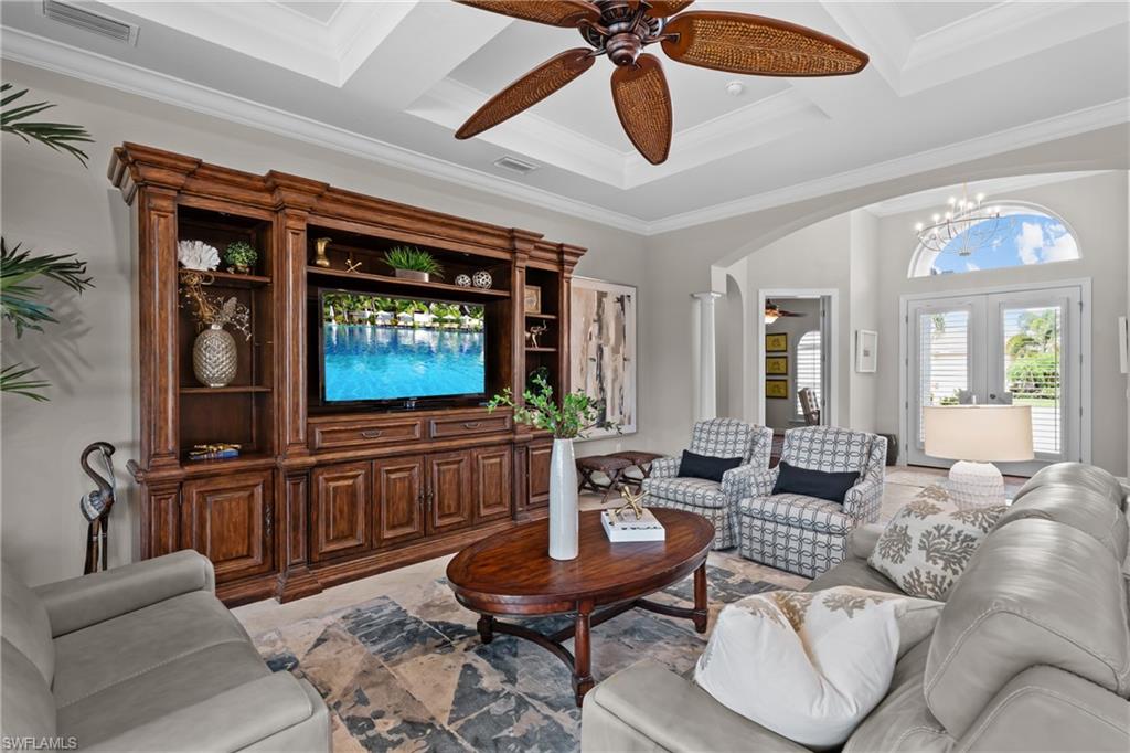 9774 Nickel Ridge Circle Naples, FL 34120 - Photo 4 of 50 a living room with furniture a ceiling fan and a large window