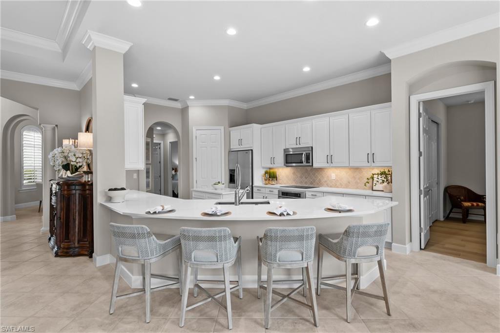 9774 Nickel Ridge Circle Naples, FL 34120 - Photo 6 of 50 a large kitchen with a table and chairs