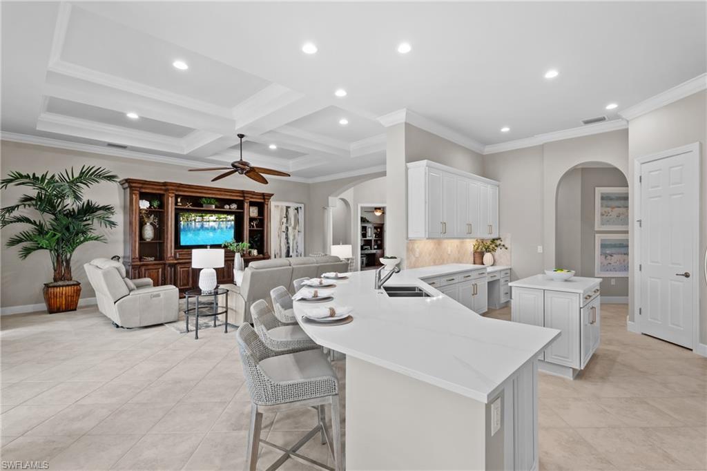 9774 Nickel Ridge Circle Naples, FL 34120 - Photo 7 of 50 a large white kitchen with a large window and stainless steel appliances