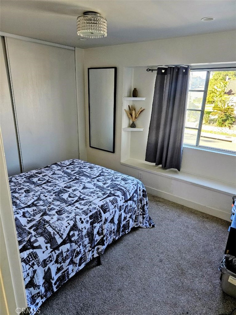 1376 Darwin Drive Oceanside, CA 92056 - Photo 11 of 22 a bedroom with a bed and a dresser in it