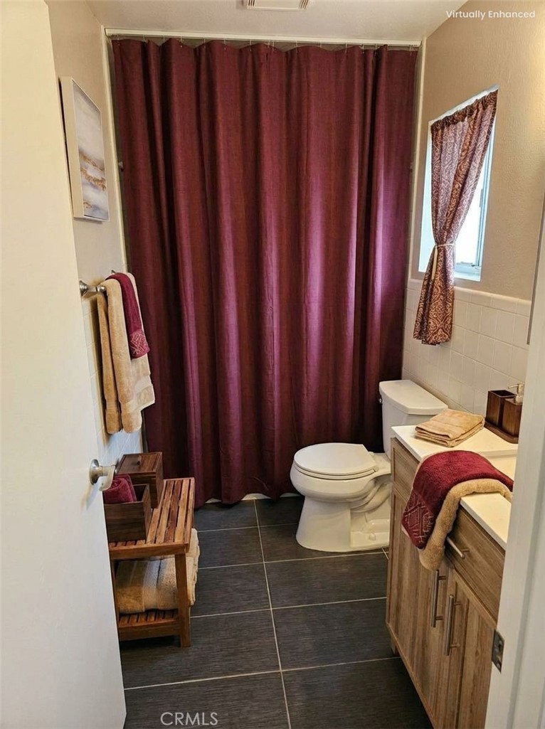 1376 Darwin Drive Oceanside, CA 92056 - Photo 14 of 22 a bathroom with a toilet a sink and mirror