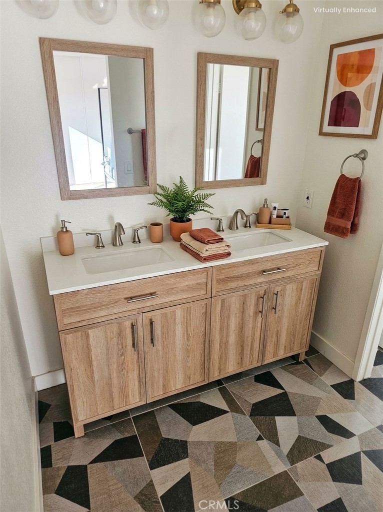 1376 Darwin Drive Oceanside, CA 92056 - Photo 17 of 22 a bathroom with a mirror and a sink
