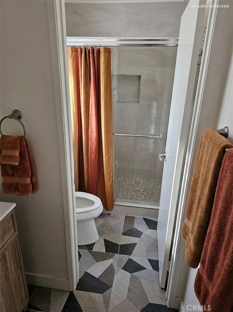 1376 Darwin Drive Oceanside, CA 92056 - Photo 18 of 22 a bathroom with a granite countertop sink toilet and shower