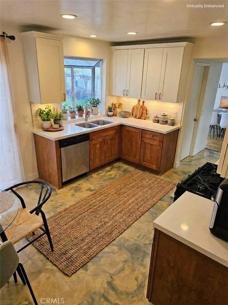 1376 Darwin Drive Oceanside, CA 92056 - Photo 22 of 22 a room with stainless steel appliances kitchen island granite countertop a sink and cabinets