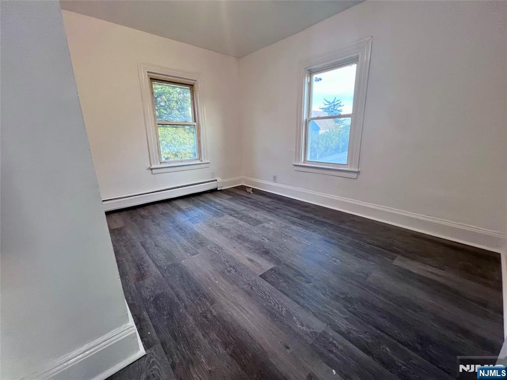 17 North Summit Street, Unit 2 Bergenfield, NJ 07621 - Photo 2 of 13 an empty room with wooden floor and windows