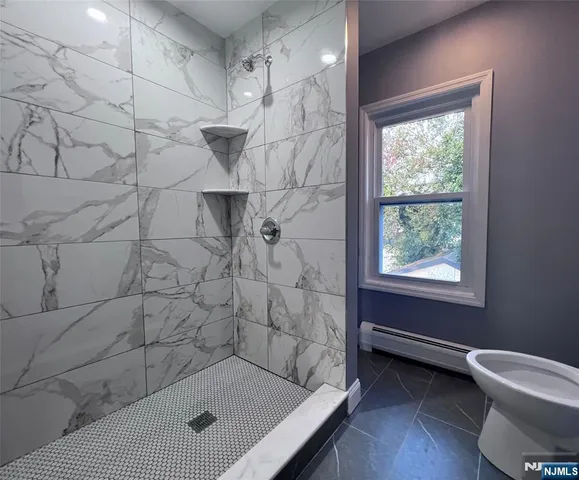 a bathroom with a shower and a toilet