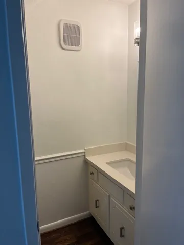 a kitchen with white cabinets a sink and a stove