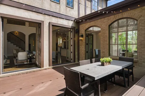 a view of a dinning tables and chairs in patio of the house