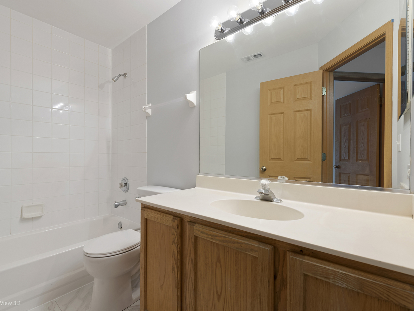 67 Colonial Court Streamwood, IL 60107 - Photo 16 of 25 a bathroom with a sink a toilet and shower