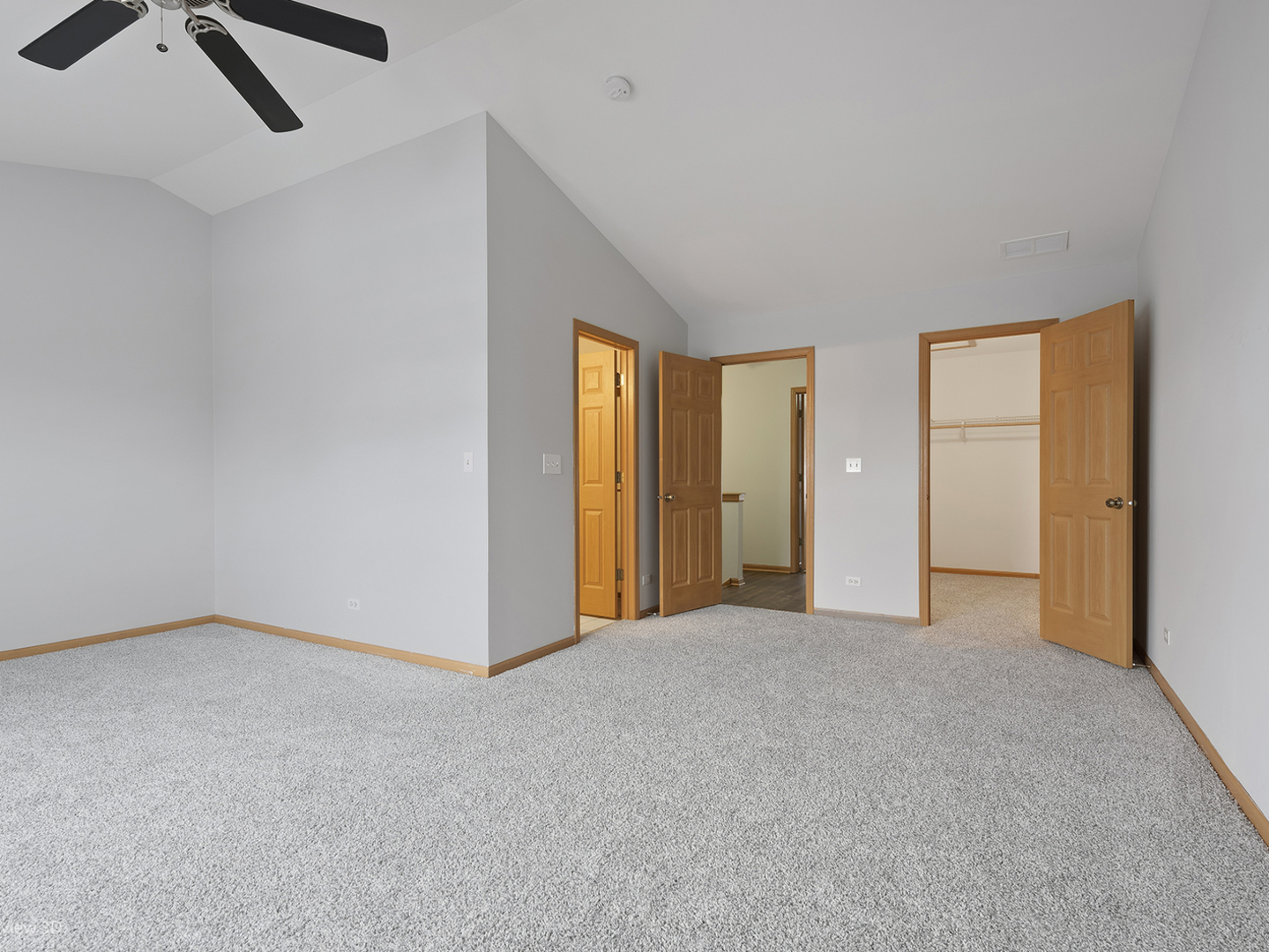 67 Colonial Court Streamwood, IL 60107 - Photo 18 of 25 an empty room with closet and chandelier fan