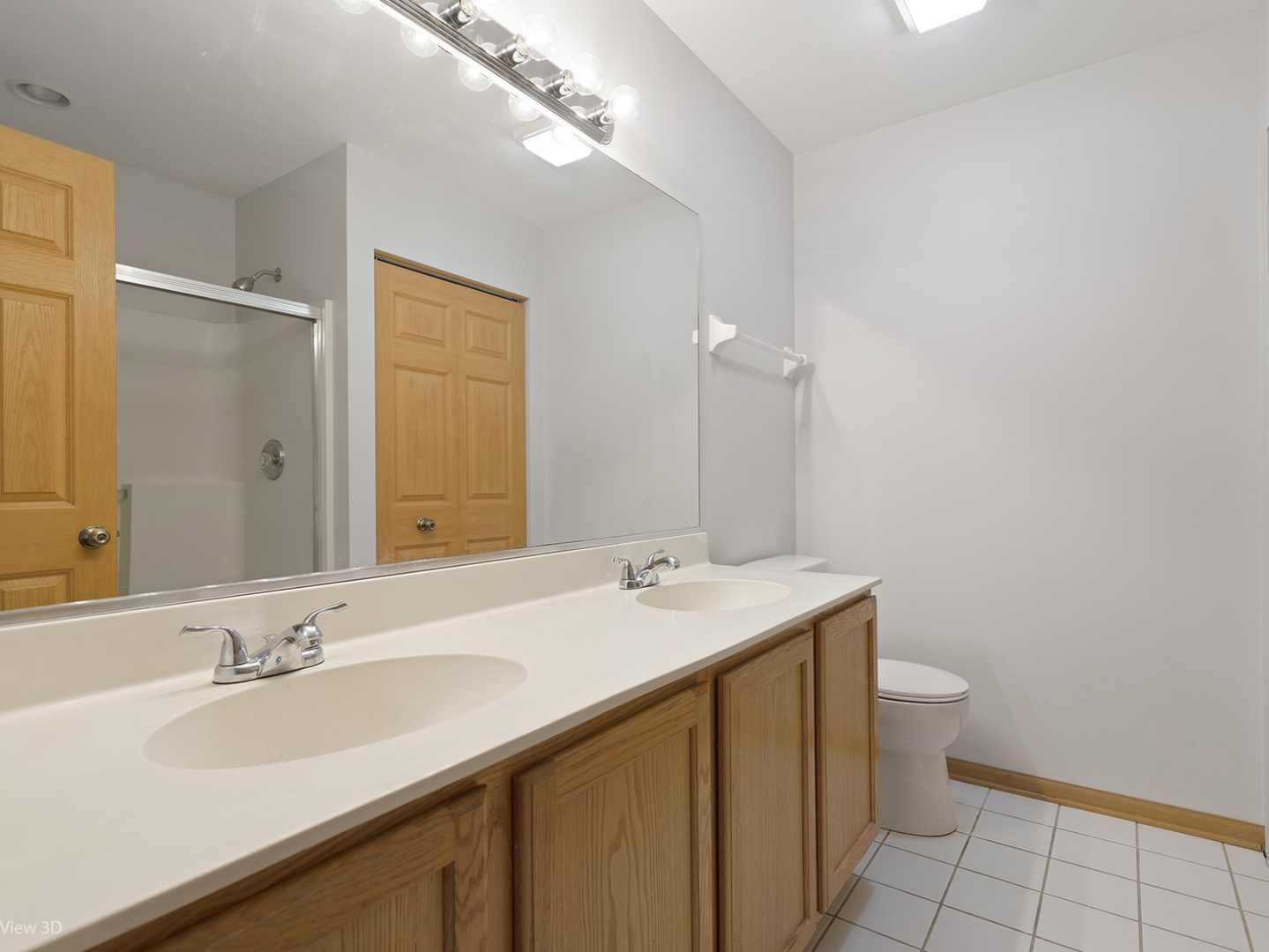 67 Colonial Court Streamwood, IL 60107 - Photo 19 of 25 a bathroom with a sink and a mirror