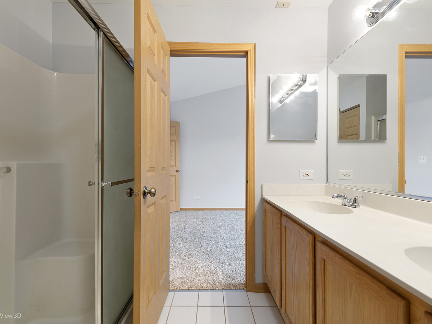 67 Colonial Court Streamwood, IL 60107 - Photo 20 of 25 a bathroom with a sink and a mirror