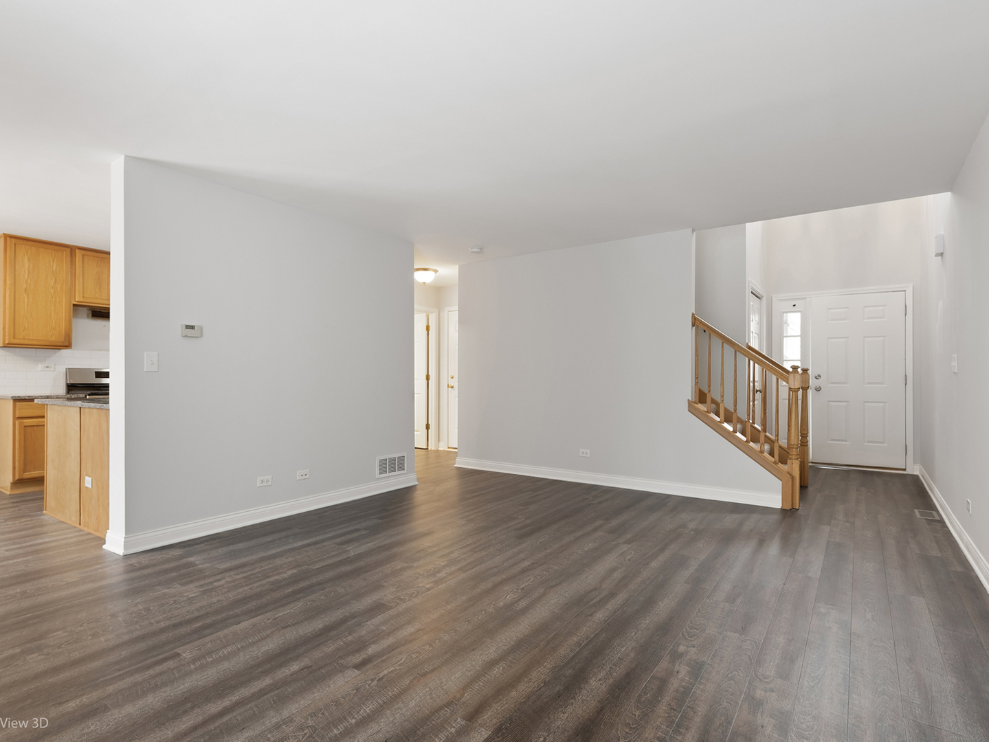 67 Colonial Court Streamwood, IL 60107 - Photo 4 of 25 a view of an empty room with wooden floor