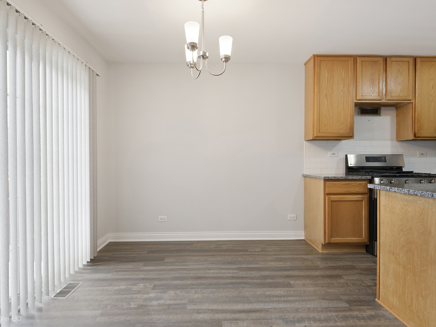 67 Colonial Court Streamwood, IL 60107 - Photo 5 of 25 an empty room with wooden floor and cabinet