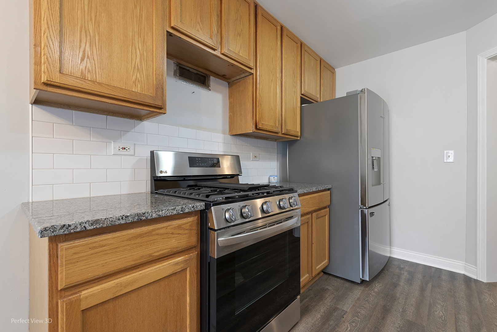 67 Colonial Court Streamwood, IL 60107 - Photo 9 of 25 a kitchen with stainless steel appliances granite countertop a stove and a refrigerator