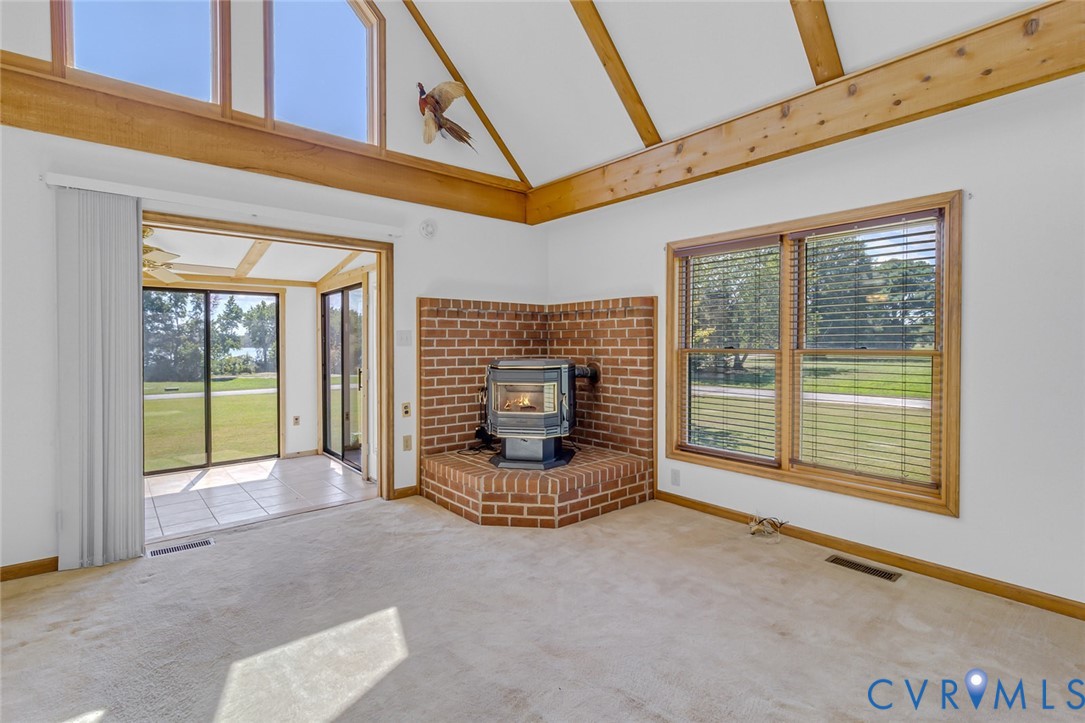 831 Fountain Gate Road Heathsville, VA 22473 - Photo 12 of 50 a view of an empty room with a fireplace and a window