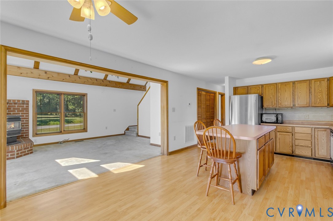 831 Fountain Gate Road Heathsville, VA 22473 - Photo 16 of 50 a view of a kitchen with furniture and wooden floor