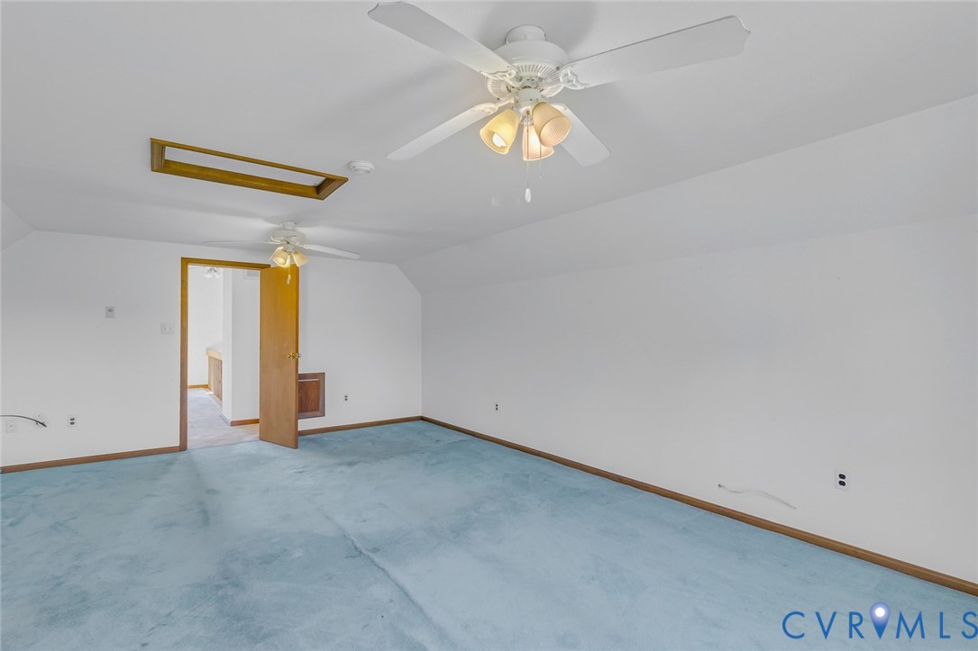 831 Fountain Gate Road Heathsville, VA 22473 - Photo 31 of 50 an empty room with a chandelier fan and windows