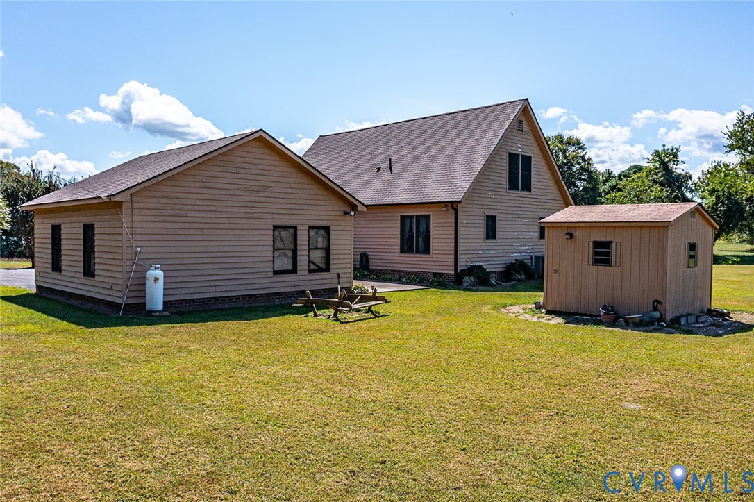 831 Fountain Gate Road Heathsville, VA 22473 - Photo 43 of 50 a backyard of a house with table and chairs