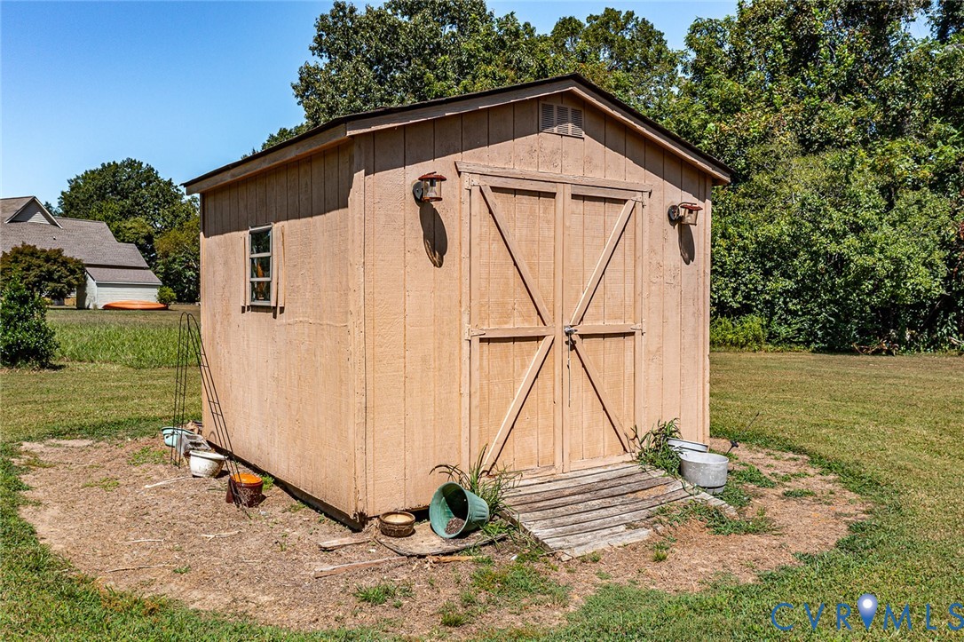 831 Fountain Gate Road Heathsville, VA 22473 - Photo 45 of 50 a view of a backyard with a table and a wooden fence