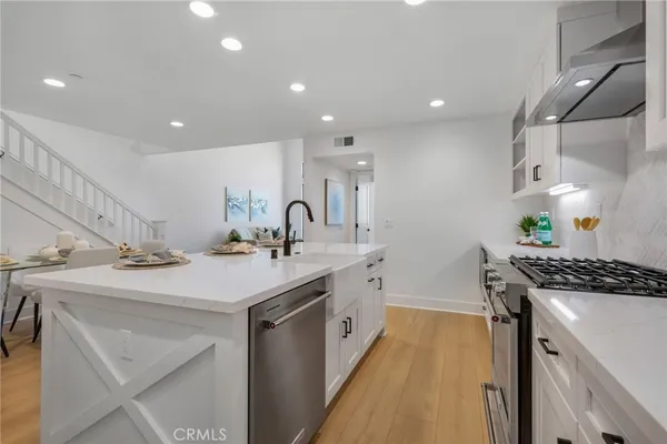 a kitchen with a sink a stove and a refrigerator