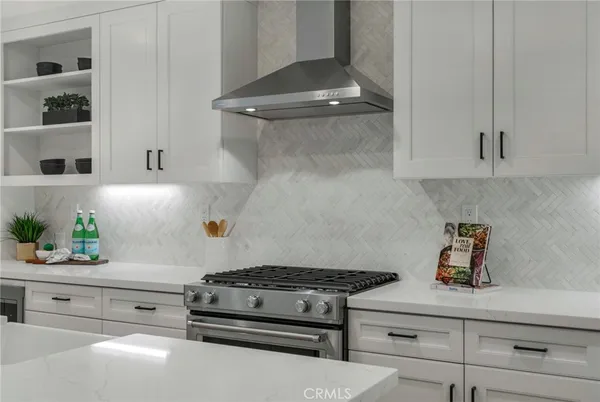 a stove top oven sitting inside of a kitchen