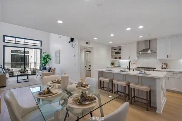 a living room with stainless steel appliances kitchen island granite countertop furniture and a kitchen view