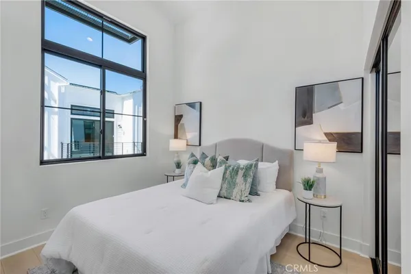 a bedroom with a bed and a window