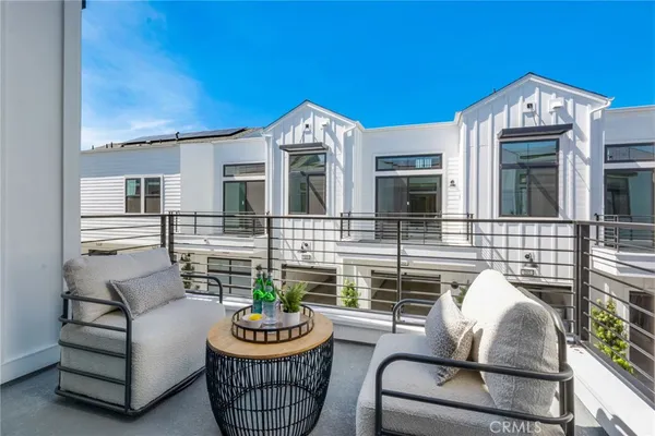 a view of a patio with couches table and chairs and potted plants