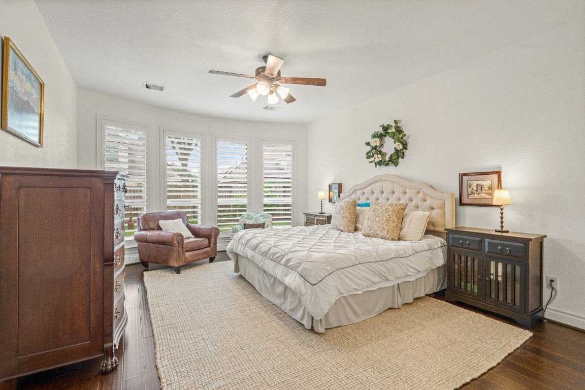 1607 Quail Ridge Drive Katy, TX 77493 - Photo 15 of 33 The primary bedroom welcomes you with engineered wood floors, bright natural light, and an upgraded bay window with a perfect view of the serene yard. It sits at the back of the home offering additional privacy and tranquility!