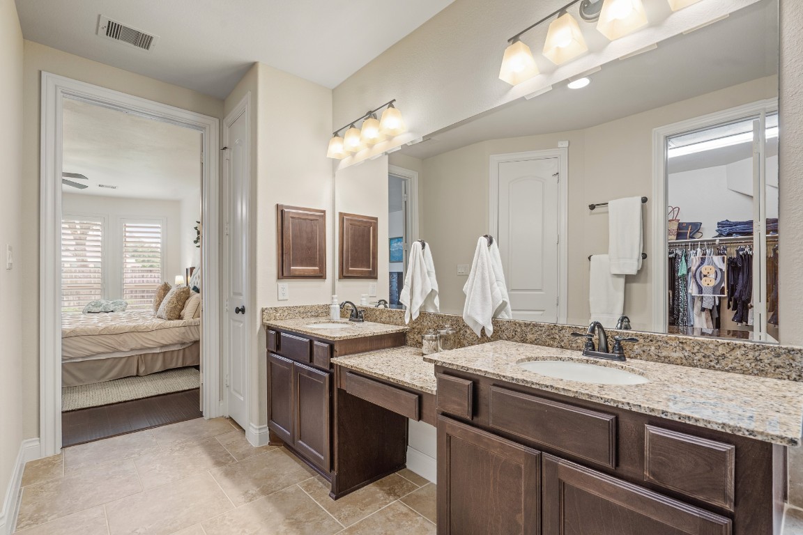 1607 Quail Ridge Drive Katy, TX 77493 - Photo 17 of 33 This luxurious master ensuite bathroom features dual vanities, granite countertops, and an oversized mirror. Enjoy a bright, open layout and a massive shower for added convenience and comfort.