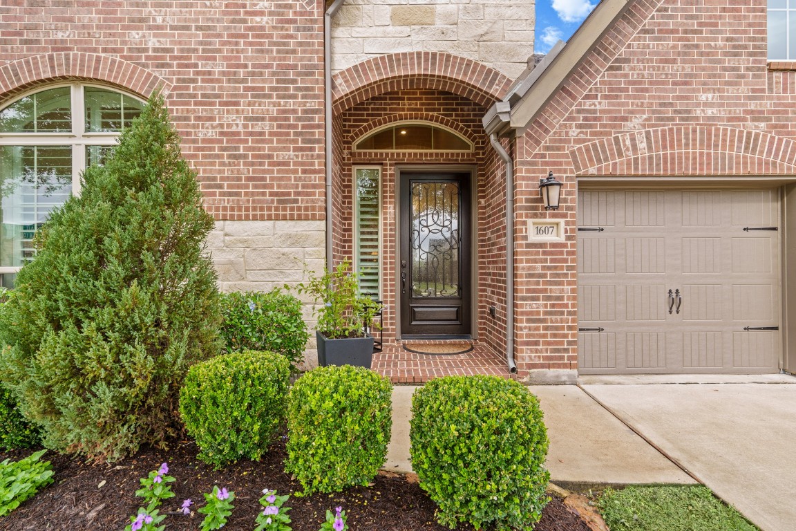 1607 Quail Ridge Drive Katy, TX 77493 - Photo 2 of 33 This charming entryway features a spacious front porch, an 8ft front door, beautiful stonework, and a warm, inviting ambiance. Who wouldn’t love coming home to this?