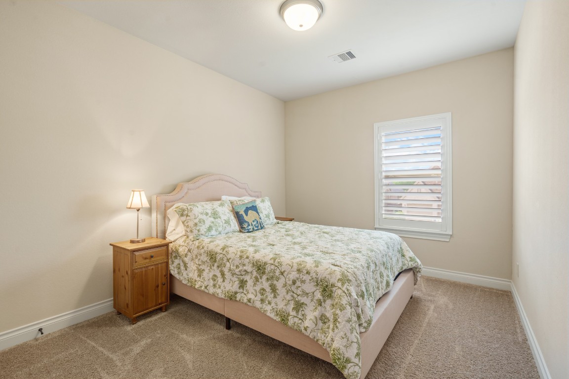 1607 Quail Ridge Drive Katy, TX 77493 - Photo 24 of 33 The first of two large secondary bedrooms upstairs, which could be perfect for anyone in the family, with plenty of closet space, plush carpet and it's located next to the upstairs secondary bathroom.