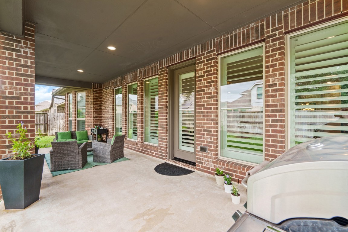 1607 Quail Ridge Drive Katy, TX 77493 - Photo 30 of 33 Your covered patio overlooks your huge backyard with plenty of green space to enjoy!