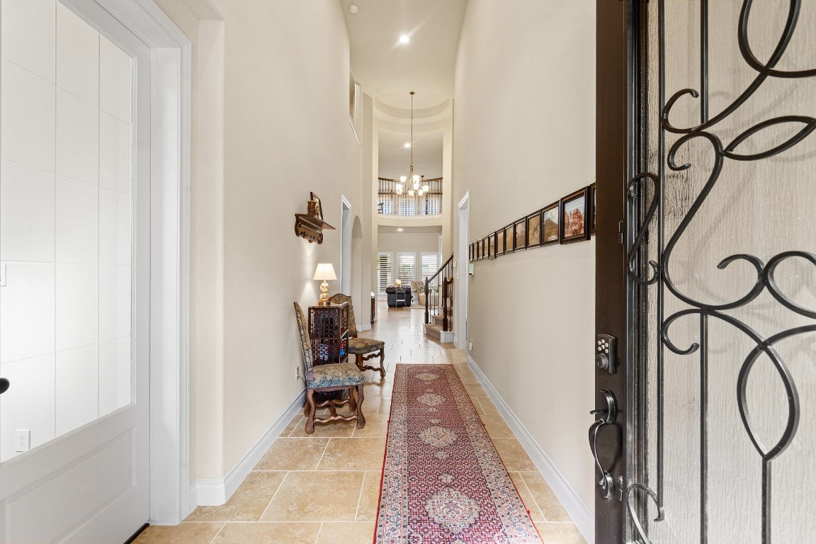 1607 Quail Ridge Drive Katy, TX 77493 - Photo 3 of 33 Step into this grand entryway with elevated ceilings and beautiful tile floors that welcome you in style. Featuring glass French doors leading into the office and abundant natural light pouring into the foyer, this space sets the tone for the home’s refined design and luxurious feel.