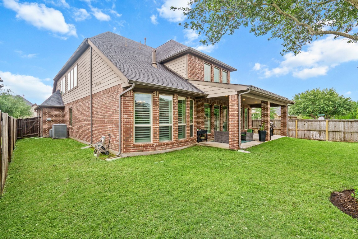 1607 Quail Ridge Drive Katy, TX 77493 - Photo 32 of 33 Imagine the space you can create in this spacious backyard! It has room for a play set, outdoor kitchen, or a pergola! Your covered patio overlooks your backyard with plenty of green space to enjoy!