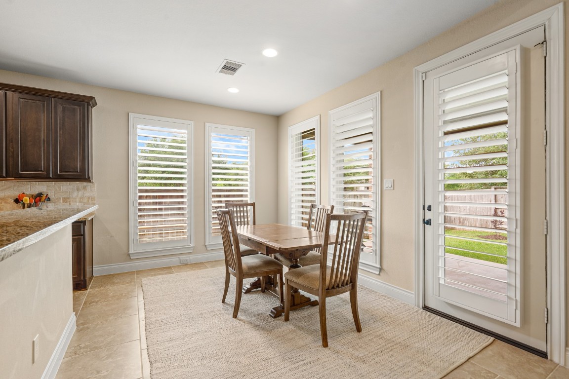 1607 Quail Ridge Drive Katy, TX 77493 - Photo 10 of 33 An open-concept breakfast area flows seamlessly into the kitchen and living area with an abundance of natural light, and a warm, inviting atmosphere. This home truly is perfect for casual or curated dining with a thoughtful design throughout.