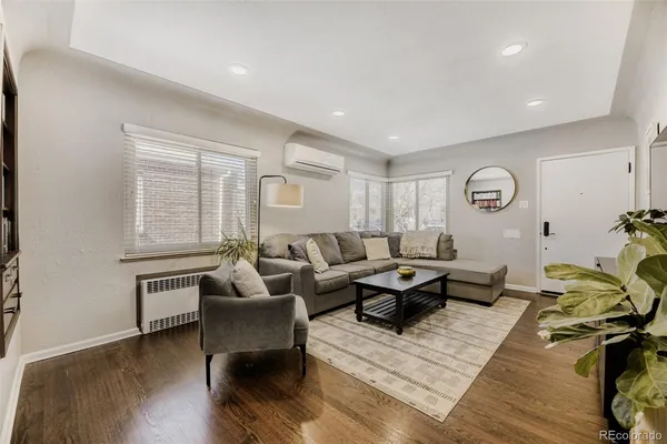 a living room with furniture window and wooden floor