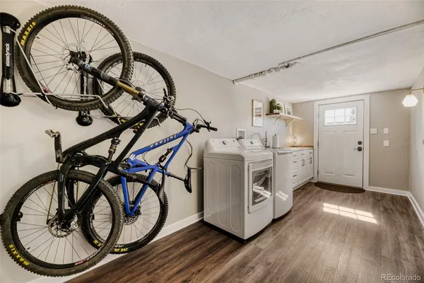 a kitchen with a white cabinets a sink and a stove with wooden floor