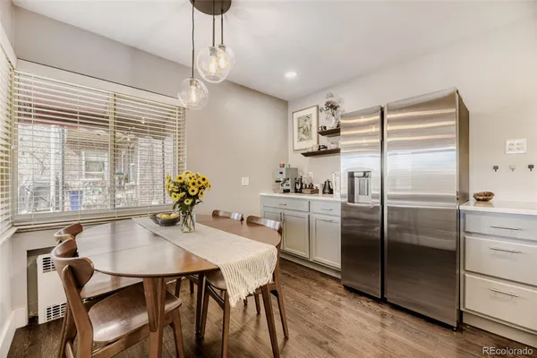 a kitchen with refrigerator cabinets dining table and chairs