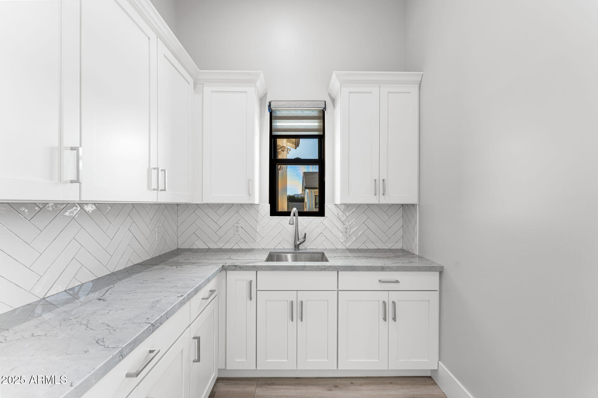 24614 South 183rd Street Gilbert, AZ 85298 - Photo 11 of 45 a kitchen with granite countertop white cabinets and a sink