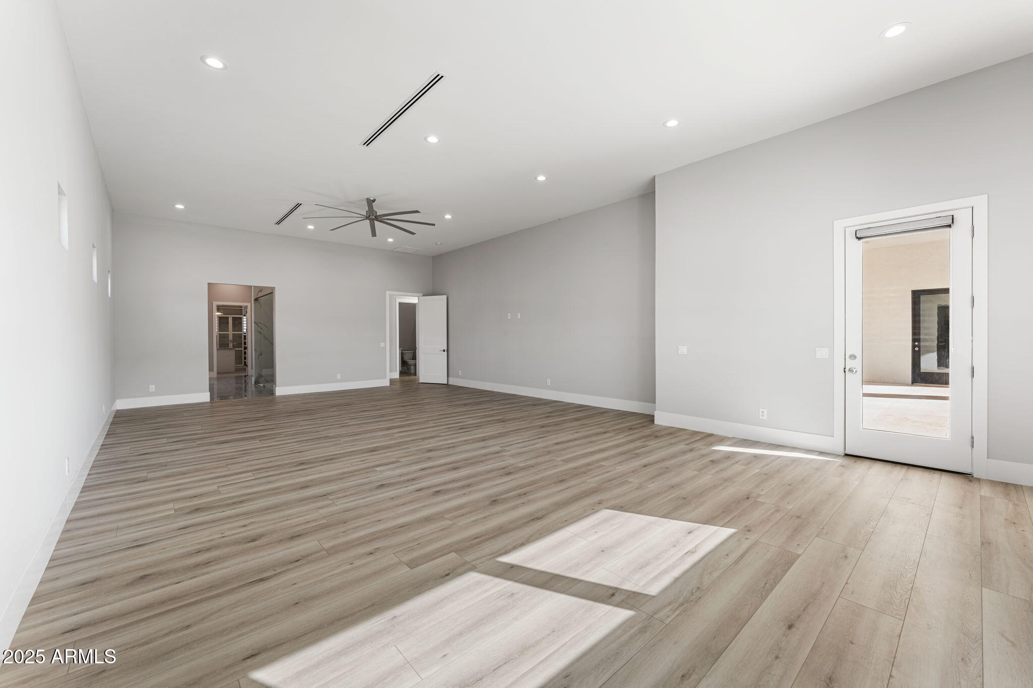 24614 South 183rd Street Gilbert, AZ 85298 - Photo 19 of 45 a view of an empty room with wooden floor and a window