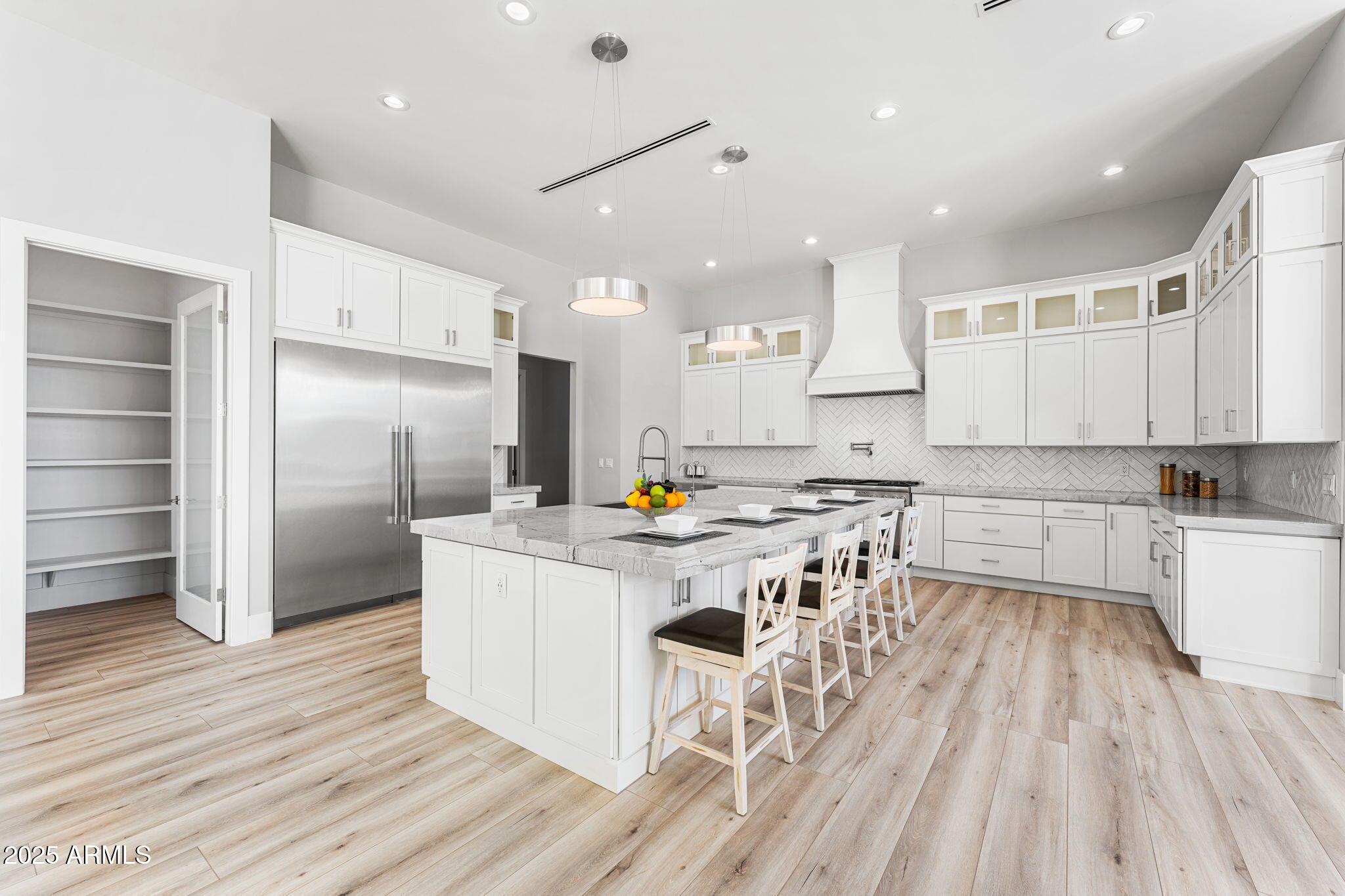 24614 South 183rd Street Gilbert, AZ 85298 - Photo 5 of 45 a kitchen with white cabinets and stainless steel appliances