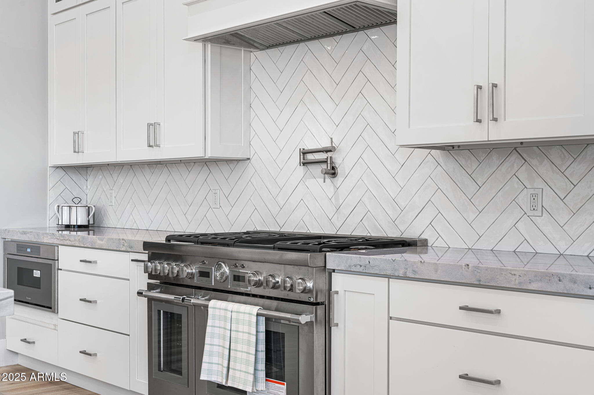 24614 South 183rd Street Gilbert, AZ 85298 - Photo 9 of 45 a kitchen with granite countertop white cabinets and stainless steel appliances