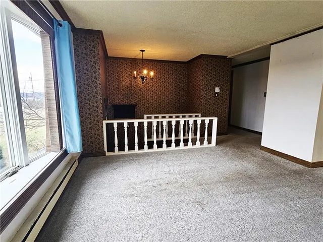 a view of a hall with furniture and window