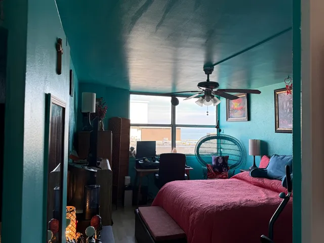 a bedroom with a bed dresser and a window