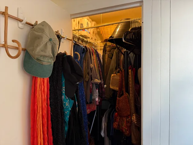 a view of walk in closet with clothes and shoes