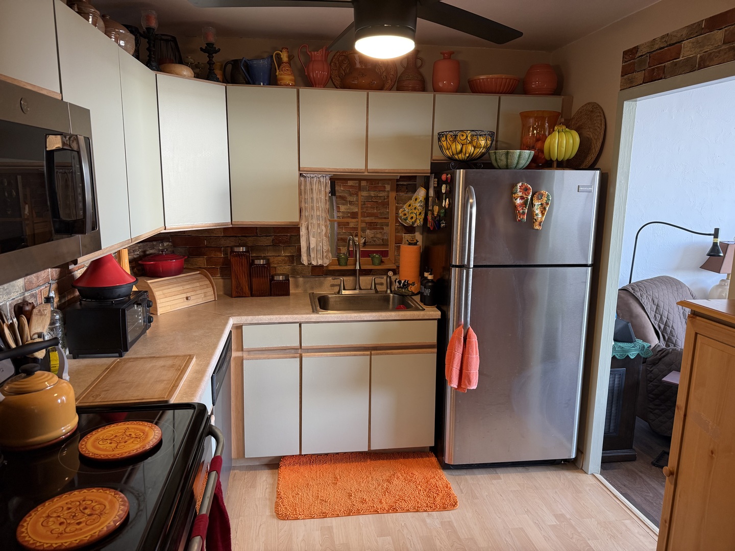 6301 North Sheridan Road, Unit 24C Chicago, IL 60660 - Photo 4 of 27 a kitchen with a refrigerator sink and cabinets