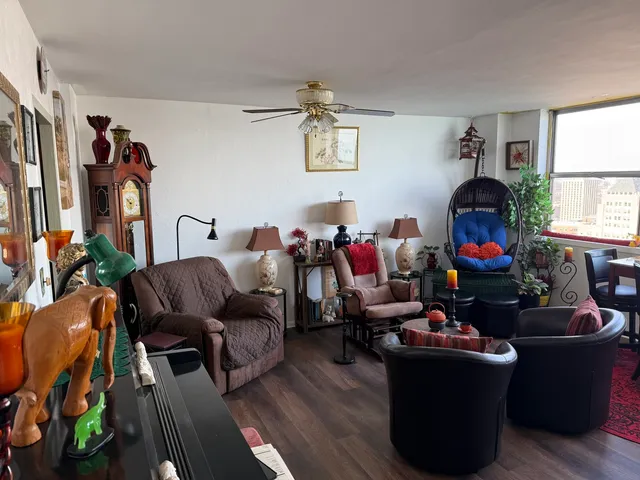 a living room with furniture and wooden floor